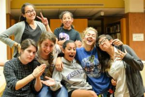 High Schoolers hang out and laugh in their pajamas before going to bed in the Archer Library.