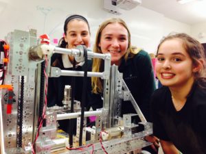 Robotics Team captains Ari Brown '16, Sofia Garrick '16 and Reanna Wauer '16 pose with their semi-completed robot before a competition. The team meets in the Sabaan IDEA Lab on Wednesdays at lunch. Photographer: Syd Stone '16.