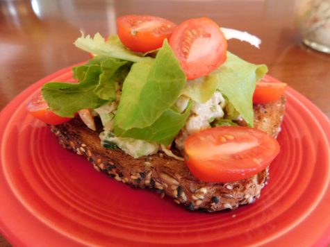 Chickpea Salad Toast, plated over whole wheat bread with lettuce and tomatoes.