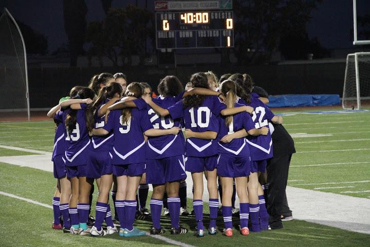 The Archer Varsity huddles in anticipation for the forthcoming game. 
Bryan Cranston/Picasa Web Album