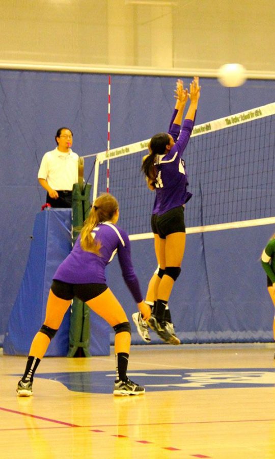 Senior Lauryn Brame blocks incoming hit from Providence, and helps Archer to gain the point. Photographer: Marlee Rice
