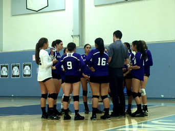 Varsity Volleyball team meets during a timeout to discuss play tactics for next game. Photographer: Haley Kerner 16