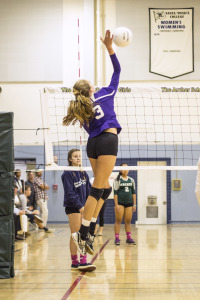 Christian Luhnow '16 jumps high and gets ready to hit the ball to her opponents, ready to get a kill. Photographer: Shishi Shomloo '15