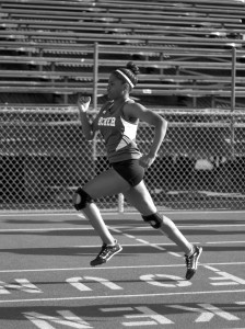 Kendra Casey '16 finishes the 100 meter dash with a long stride. Photographer: Shishi Shomloo '15
