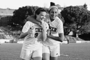 Kiley smiles during a mid game moment with soccer captain Yasmeen Namazie '15.  Photographer; Shishi Shomloo '15