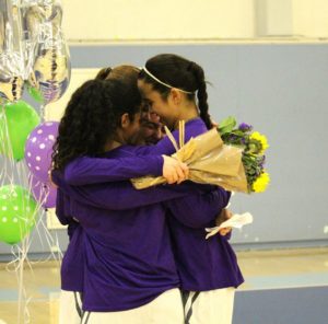 Roberts hugs basketball teammates after Senior Night last year. The 6'1" sophomore played point guard and shooting guard. Used with permission from Marlee Rice.