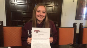 Christian Luhnow poses with her letter of intent to Lafayette College. Lafayette is a liberal arts school located in Easton, PA. Photo courtesy of Christian Luhnow 16.