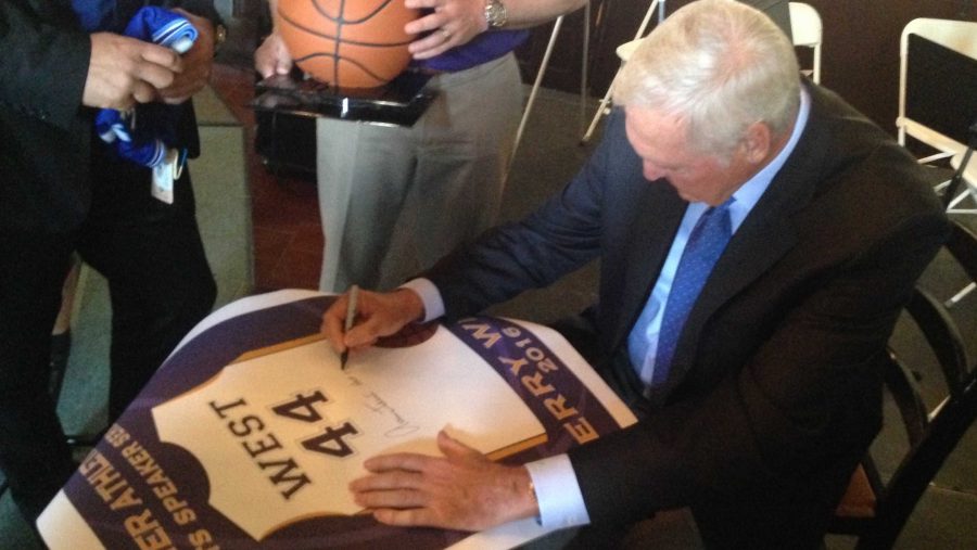 Jerry West signs a poster with a picture of his jersey following his Q&A with Athletic Director Denny Lennon on April 14. His number, 44, was retired by the Lakers on Nov. 19, 1983. 