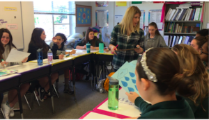 Each day the Spanish class starts with a "Do Now" as a opening assignment for the day. The students receive help from Ms. Lauster. Photographer: Chloe Davenport '19.