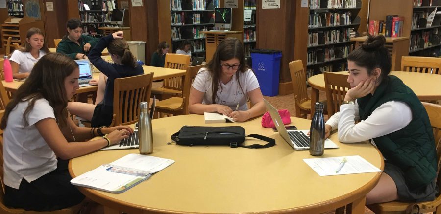 Seniors, Talia Goodman, Annie Schindel and Anabella Ronson Benenati spend their free X-Block on homework. Students have an additional X-Block in their schedule this year. 