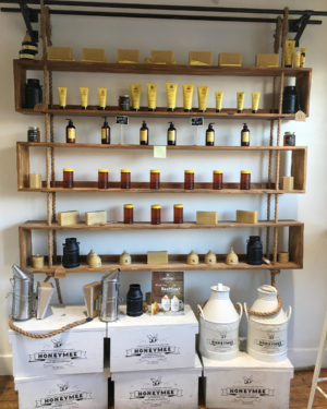 The shelves inside of Honeymee are filled with jars of honey, beeswax, lotions, and home items. 