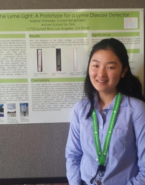 Marine Yamada 17 poses with her finalized research poster at the 2016 Archer STEM Symposium. Yamada won a RISE (Research in Science and Engineering) Award at the conference and, having continued her research, has now been recognized by TakePart magazine and actor Ashton Kutcher. Photo courtesy of Yamada. 