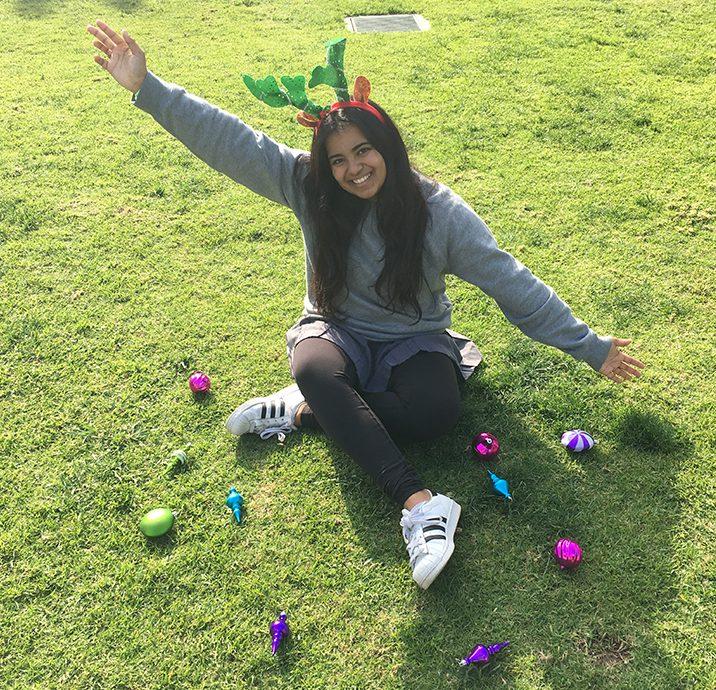 Editor-in-Chief Anika Bhavnani poses with holiday themed decorations. Bhavnani is going into her last semester of her Archer career. 
