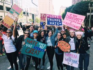 Archer seniors Leyla Namazie, Isabelle Wilson, Clara Gasparetti, Rachel Pike, Carly Feldman, Eloise Rollins-Fife, Liadan Solomon, Audrey Koh, Isabel Adler, Ingrid Sant and junior Gemma Brand-Wolf pose for a photo at the Womens march in Downtown LA. They hand-made all of their posters. Photo Courtesy of Wilson.