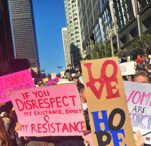 Some of the hundreds of thousands of protest signs at the Los Angeles Womens March are held high by Archer girls. Signs at the march ranged from humorous to somber and touched on a variety of social, economic and environmental justice-related issues.