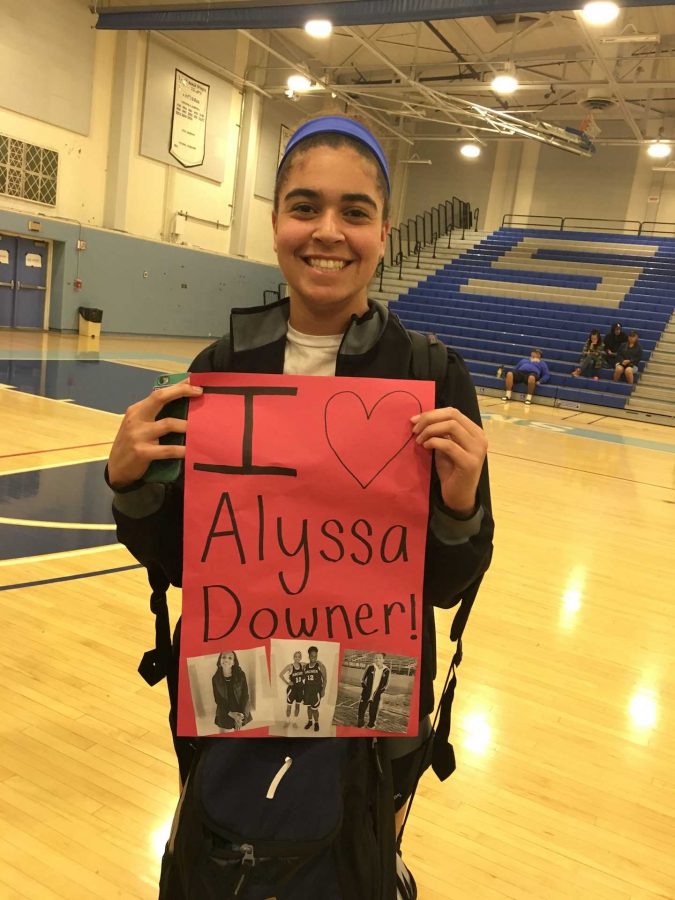 Soccer player Rachel Pike holds up a sign cheering on Alyssa Downer at the teams final game. 