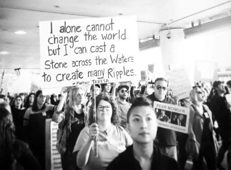 A protestor at LAX holds a sign with a quote from Mother Theresa on Jan. 29. Thousands of protestors gathered at airports around the world after President Trump signed an executive order banning seven predominantly Muslim countries. 

Photo courtesy of Banafsheh Salimi.