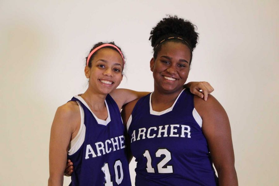 From left to right, seniors Alyssa Downer and Briana Johnson pose for a photo at the beginning of the season. The pair are the only seniors on the basketball team.