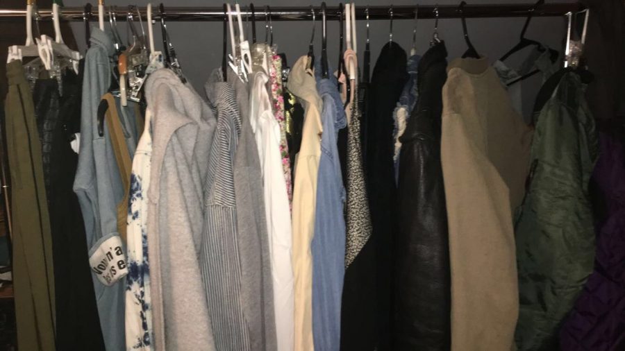 A clothing rack with clothes from several different fast fashion brands. Clothing like this harms the environment and the workers who make it.