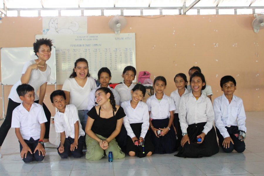 Madison Tyler 19, Angelica Gonzalez 20 and Megan Escobar 19 pose with Cambodian school children. 13 students traveled to Cambodia  through the latest Archer Abroad trip. 