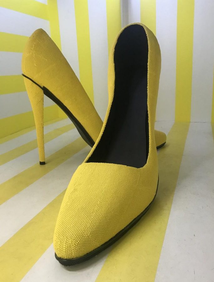 A giant pair of high heels stands in the center of one of the rooms at Happy Place. Happy Place is located in Downtown.