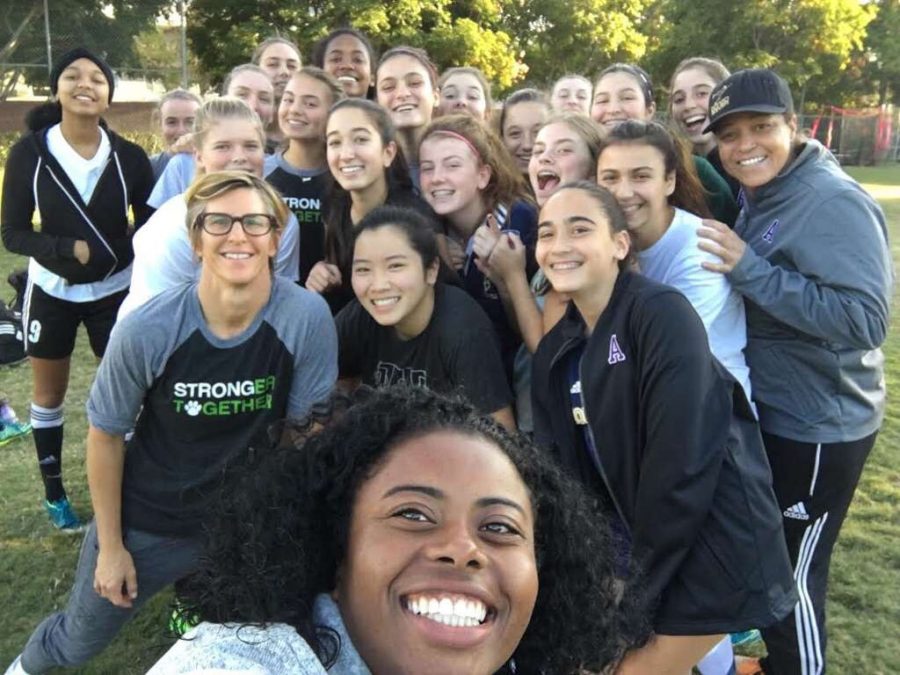 The varsity soccer team poses for a selfie after a practice. The team is working on becoming more cohesive players on the field. 