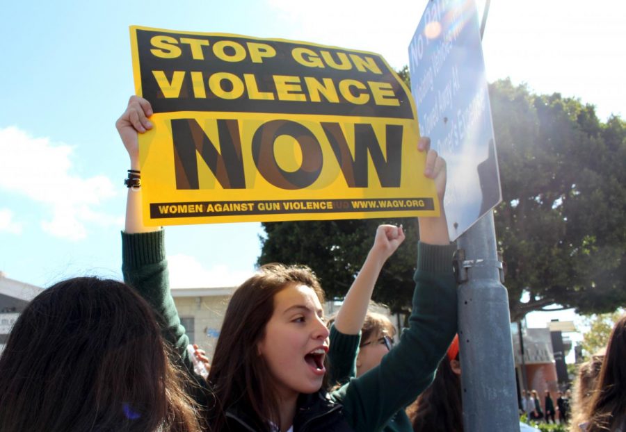 Sarah Khneysser 20 holds up a Stop Gun Violence Now sign during the #ENOUGH National School Walkout. After a few planned minutes of silence in the courtyard, high school students unexpectedly marched off campus to protest on Sunset Blvd.