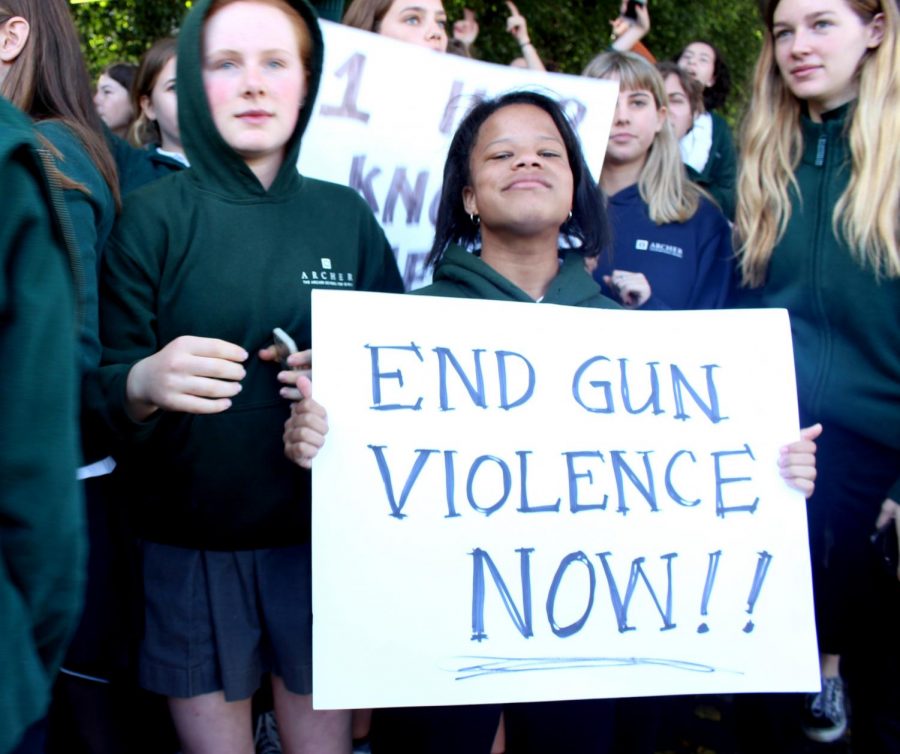 Jayla Brown 18 holds a sign that says End Gun Violence Now during the National Walkout on Mar. 14. The walkout caused difficult yet necessary conversations around campus. The Editorial Board encourages students to continue to advocate against gun violence in schools. 