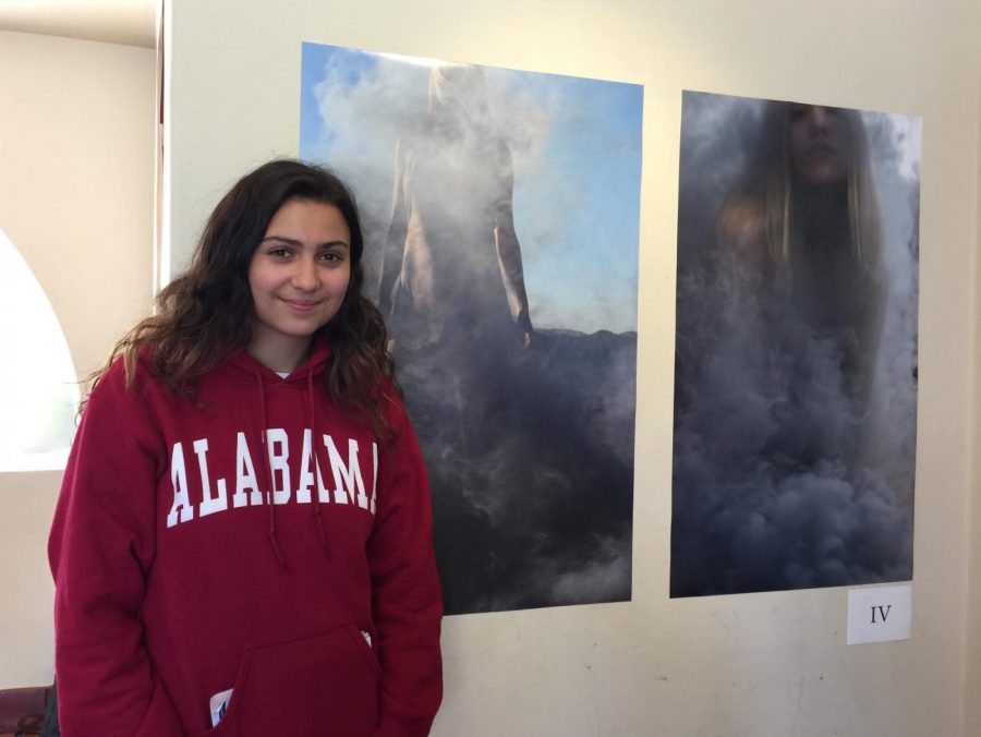 Caitlin Mosch 18 poses with her art during the show opening on Tuesday.  Mosch spent the year shooting and editing pictures depicting nature.