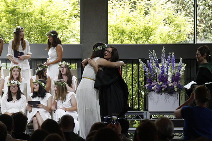 Cybele Zhang 18 embraces Head of School Elizabeth English after her name is called by Upper School Director Gretchen Warner. 