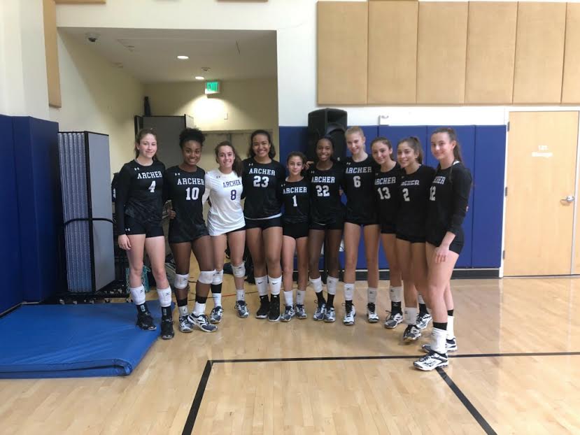 The+varsity+volleyball+team+poses+for+a+group+photo.+The+team+will+advance+to+the+second+round+of+CIF+playoffs.+