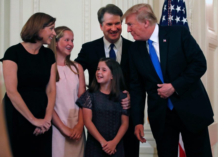Brett Kavanaugh and his family talk to President Donald Trump at the White House. Trump nominated Kavanaugh as a Supreme Court Justice on July 9. 