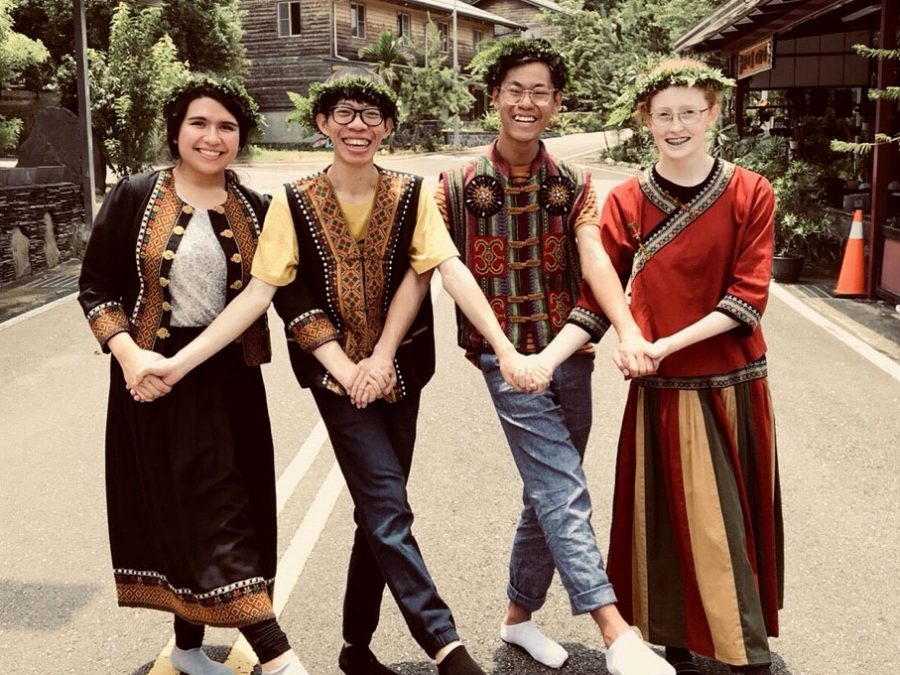 Greene poses in traditional Taiwanese clothing with two classmates and a tutor from Wenzao University. The group visited Tainan, where students learned to make aboriginal Taiwanese foods and perform dances. 
