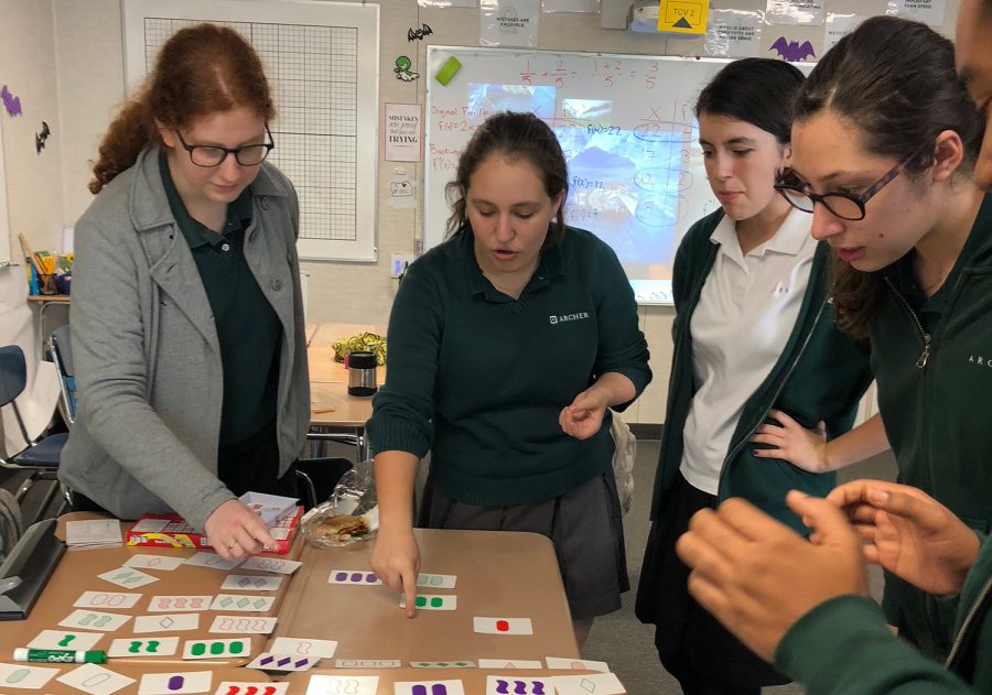 Members of the Math Team play Set, a mathematical card game which consists of finding cards that are similar or different. These findings are based on four different variables: number, color, shading and shape. Its pretty tricky, but we have some great players, club leader Lola Wolf 19 said. 