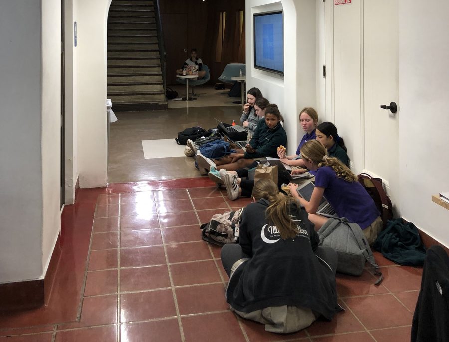 Archer students work in the hallway outside the library. The library has been closed for the past few days because a pipe burst. 
