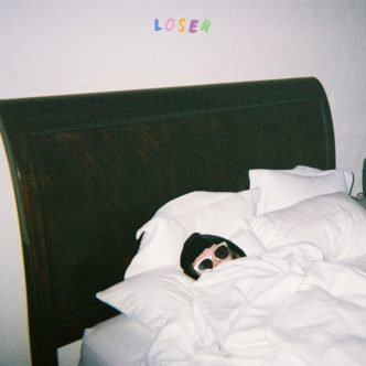 Sasha Sloan hides under the covers of her bed for the album cover of Loser. Sloans music provides an honest, relatable voice for struggling individuals.    