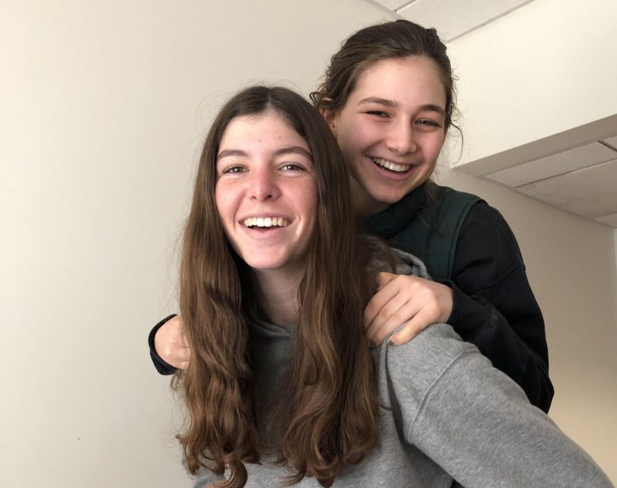Senior equestrian captains Ella Frey and Maddy Benfield smile and pose together during x-block. This is the second year that the two girls are captains.