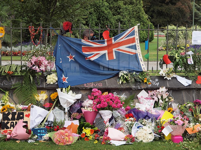 A New Zealand flag surrounded by flowers at the tribute wall set up at the Botanic Gardens.  Archer Student Support Coordinator and Junior Class Dean Jennifer Dohr was disgusted by the March 15 mosque shooting in New Zealand. 