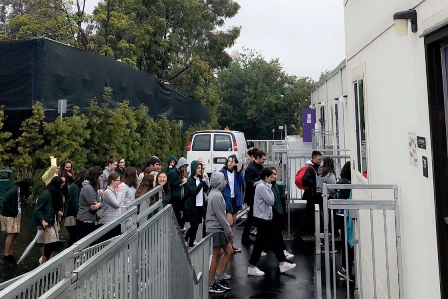 Students leaving the village courtyard after lining up during an evacuation on Thursday morning. The evacuation occurred due to a false alarm caused by construction activity.  