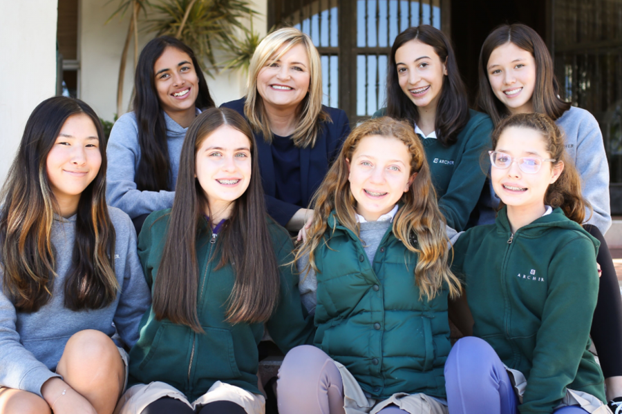 Eighth graders Uma Bajaj, Karen Pavliscak, Daisy Marmur, Genevieve Sieve, Sydney Frank, Juliet Katz, Zoe Woolenberg and Margaret Morris sit with Pavliscak on the front steps. Pavliscak is currently serving as Middle School director and Assistant Head of School and will assume the role of Associate Head at the beginning of July. 