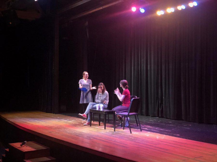Drama Queens Ava Vinton 20, Livia Blum 19 and Caroline Ediger 19 sit at the Magicoplis theater while performing The Questionnaire. In the humorous scene, a girl administers a test to her best friends new partner to ensure that the match is suitable.