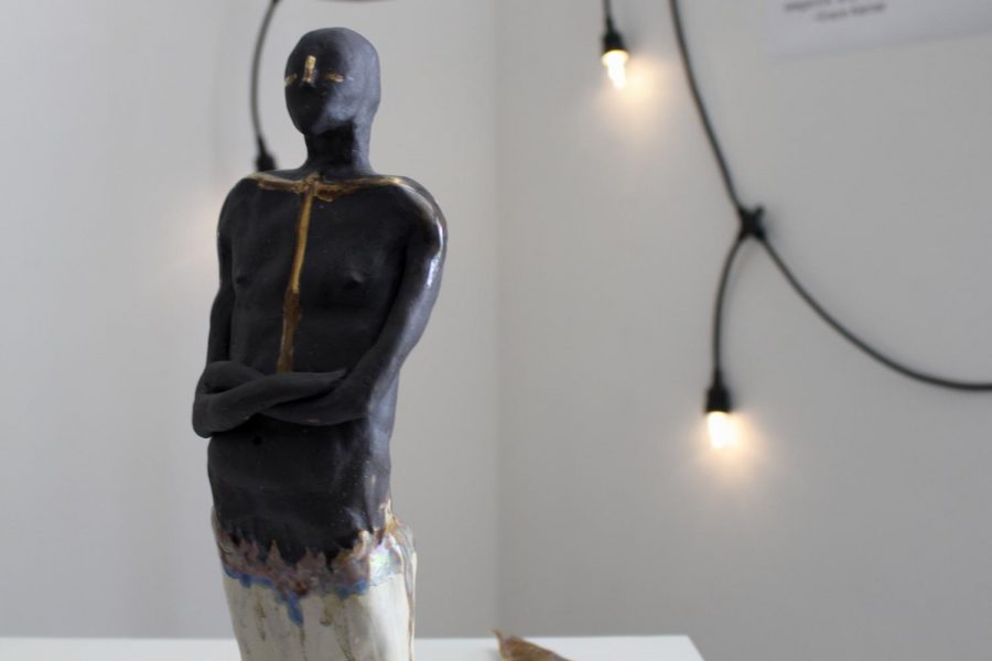 An unnamed sculpture by Archer senior Grace Kerner sits on a white podium in the Eastern Star Gallery. Kerner used different types of clay during the creative process, including speckled buff and b-mix. 