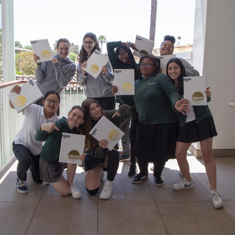 The yearbook staff, minus their two senior editors, show off the 2019 yearbook on May 29, distribution day. 