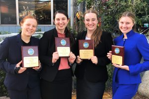 Holding their debate awards, Noa Wallock 22, Rachael Azrialy 21, Kylie Chryss-Connell 21 and Grace Carter 20 pose for a photo after competing in a speech tournament at New Roads School. Azrialy and Chryss-Connell tied for first, Wallock won first in her category and Carter got second.  