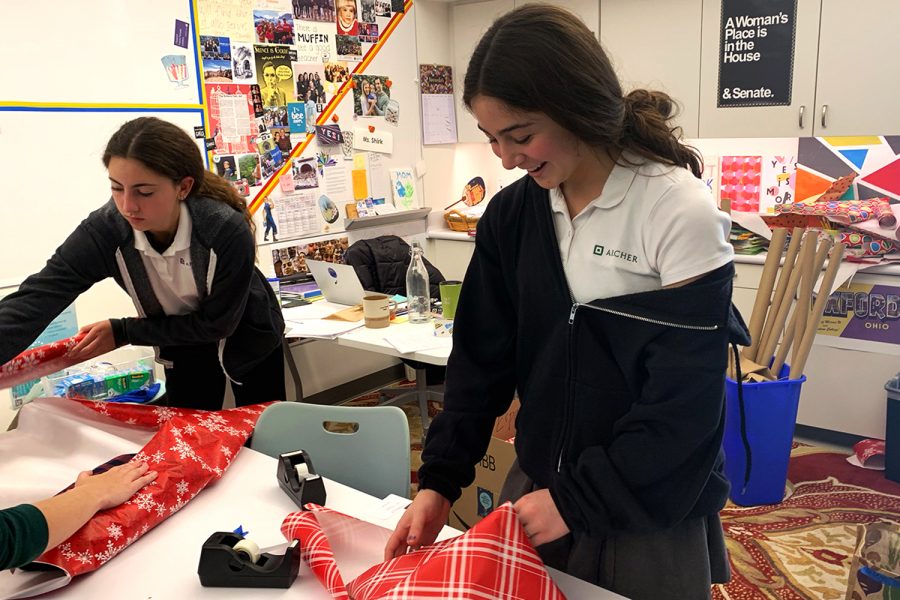 Sophomores Lily Miro and Naya Ben-Meir wrap gifts donated by students during an on-campus gift wrapping session in preparation for Dec. 14. Students will be given the opportunity to hand presents to over 450 families across the Los Angeles area.