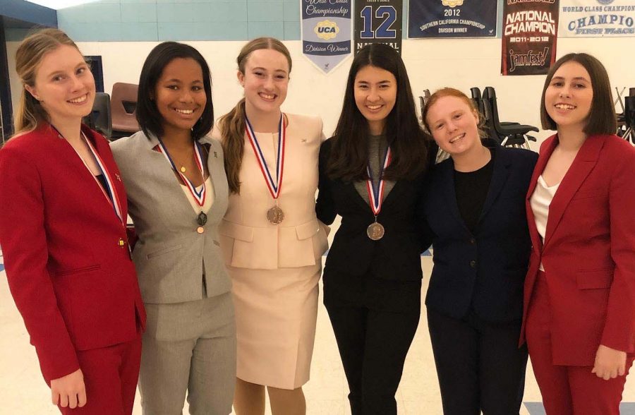 Archer Speech and Debate Team members pose with their awards after a league tournament on Saturday, Nov. 23. Although the team was only officially formed two years ago, Chryss-Connell (third from left) believes that they are at the height of their achievements this year. 