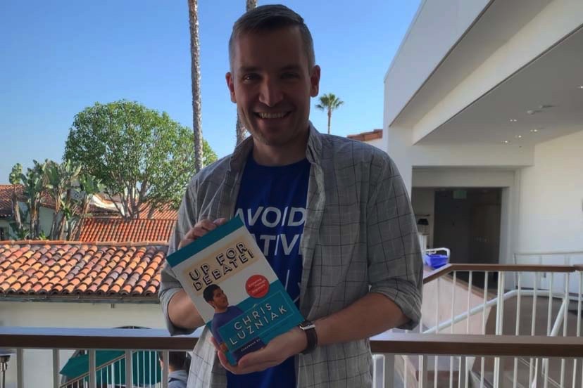 Mr.Luz holds his book Up for Debate! outside his classroom. The book was published October 2019.