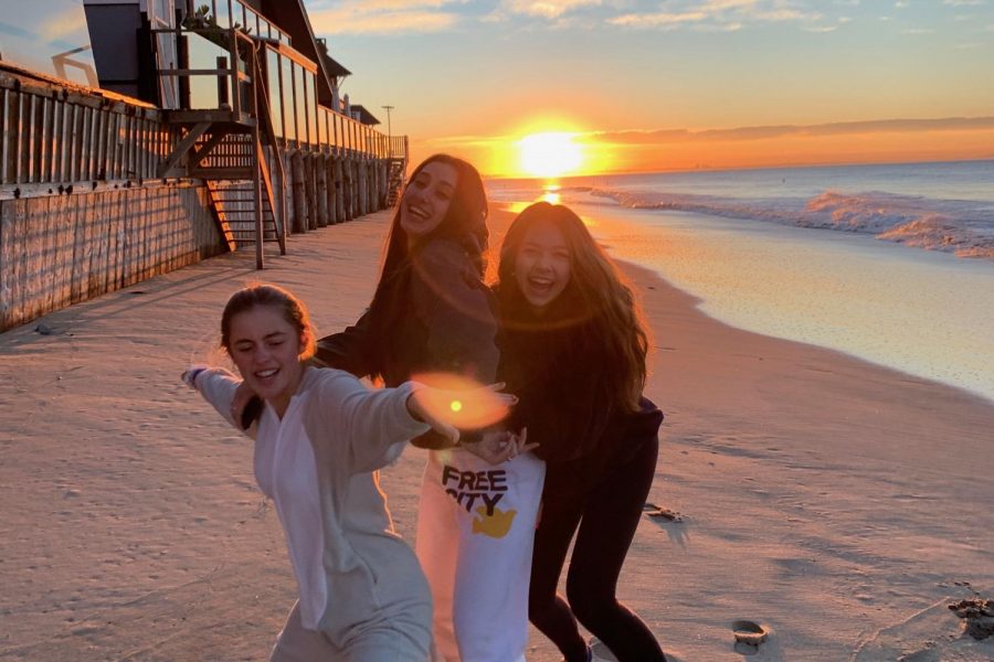 Seniors Grace Wilson, Kelsey Thompson and Charley Griffiths pose on the beach during the first sunrise of the new year. The three girls are celebrating their excitement about having arrived in 2020.