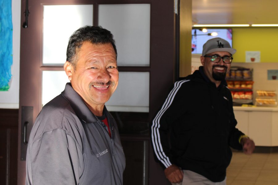Facilities staff members Isaac Velasquez and Reyes Atrian walk to the servery. Velasquez and Atrian both like to play and watch soccer in their free time and have worked together for almost three years.