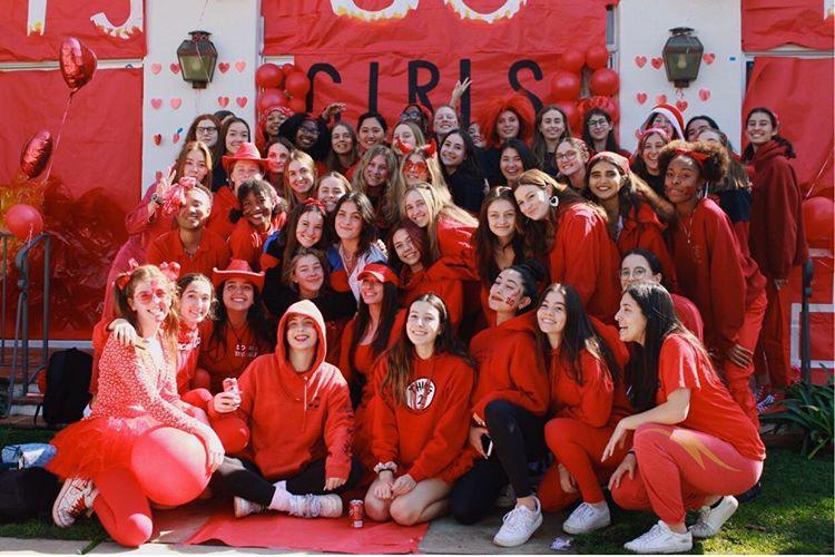 Seniors, also known as the girls on fire after being assigned the color red in Color Wars four years ago, pose in front of their banner at the Color Wars 2020 event hosted by Student Council on Feb. 14. Due to the COVID-19 outbreak, all forms of social gatherings, including graduations are prohibited until further notice. For this years annual ceremony, the class of 2020 celebrated their commencement virtually via Zoom.
